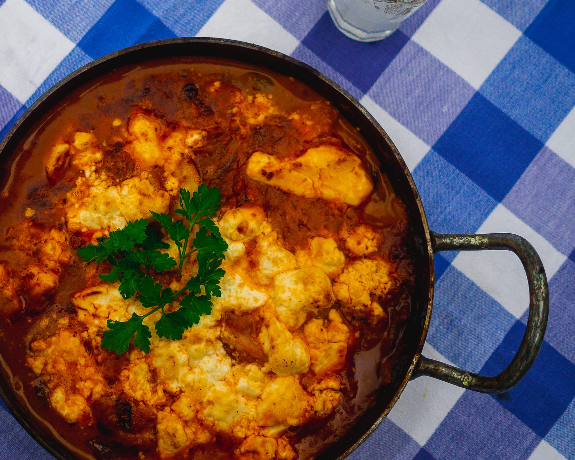 Prawn Saganaki in a Indian cast metal two handled round frying pan