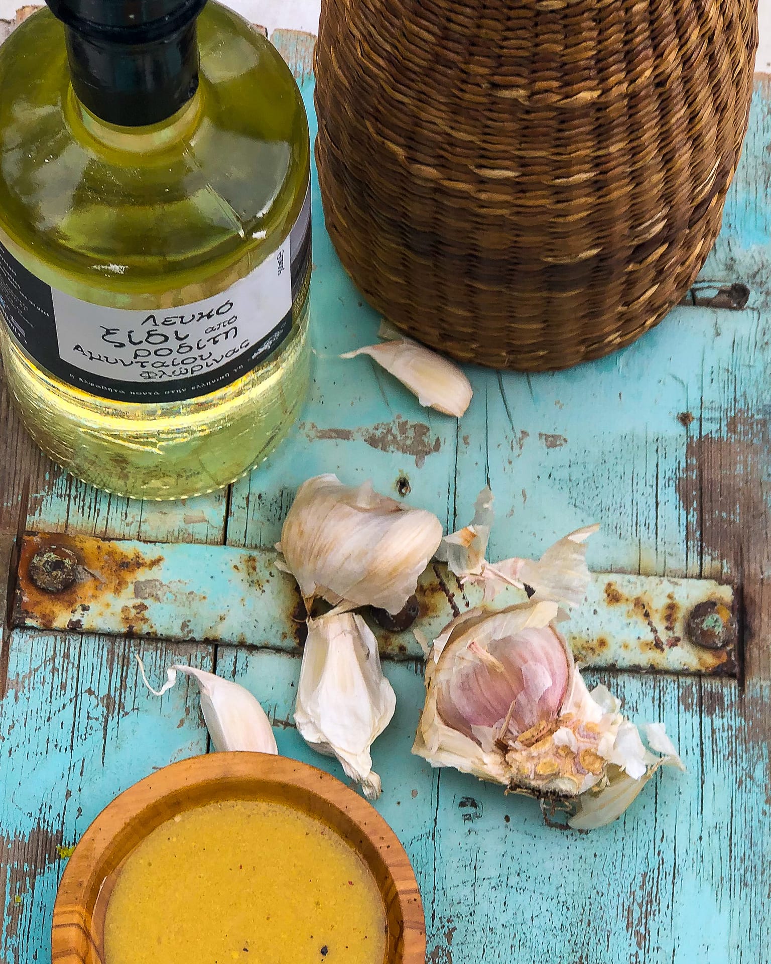 A bottle of good Vinegar on a blue table. Vinegar is key to making a good Vinaigrette