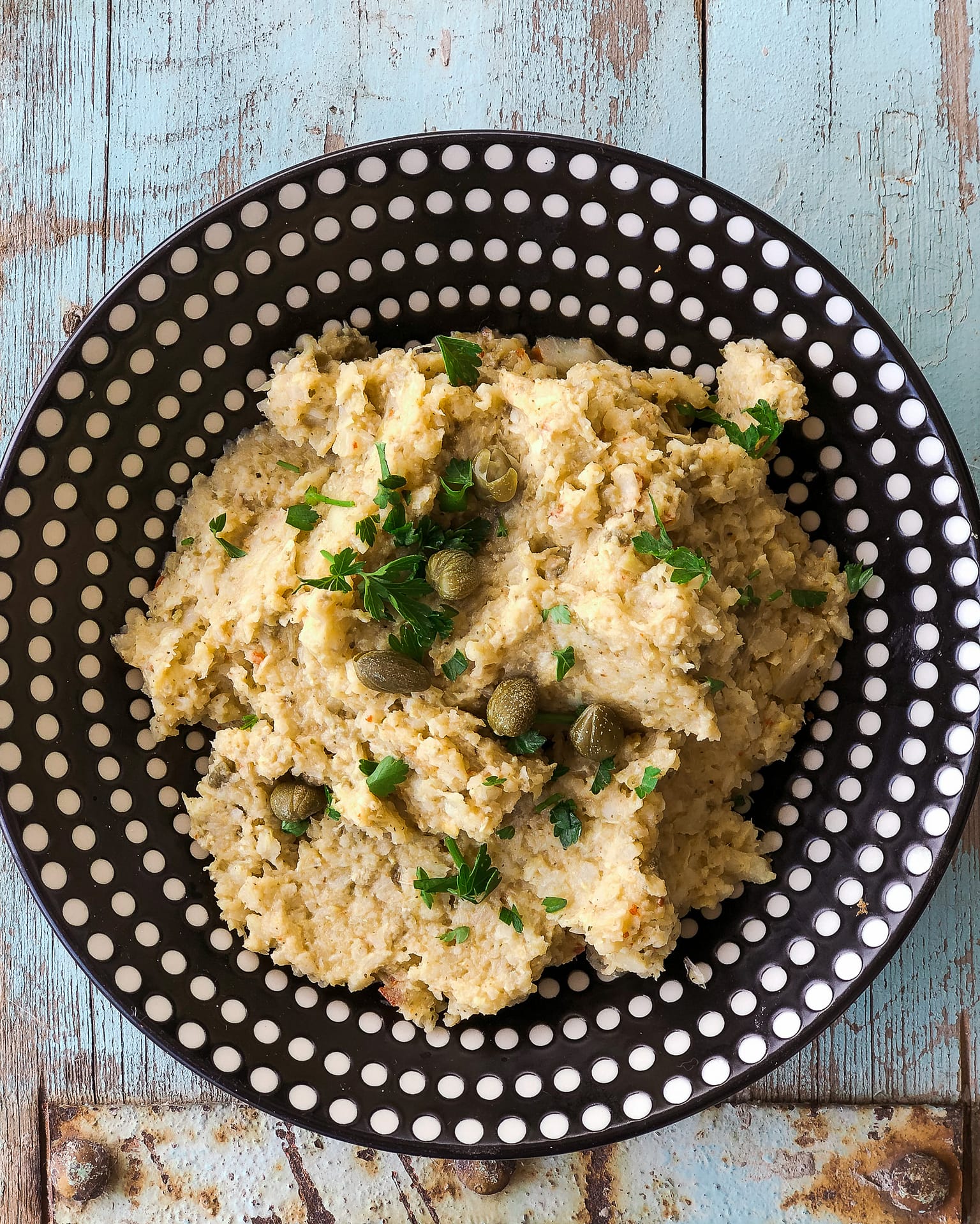 Artichoke Tapenade on a big black and white bowl.