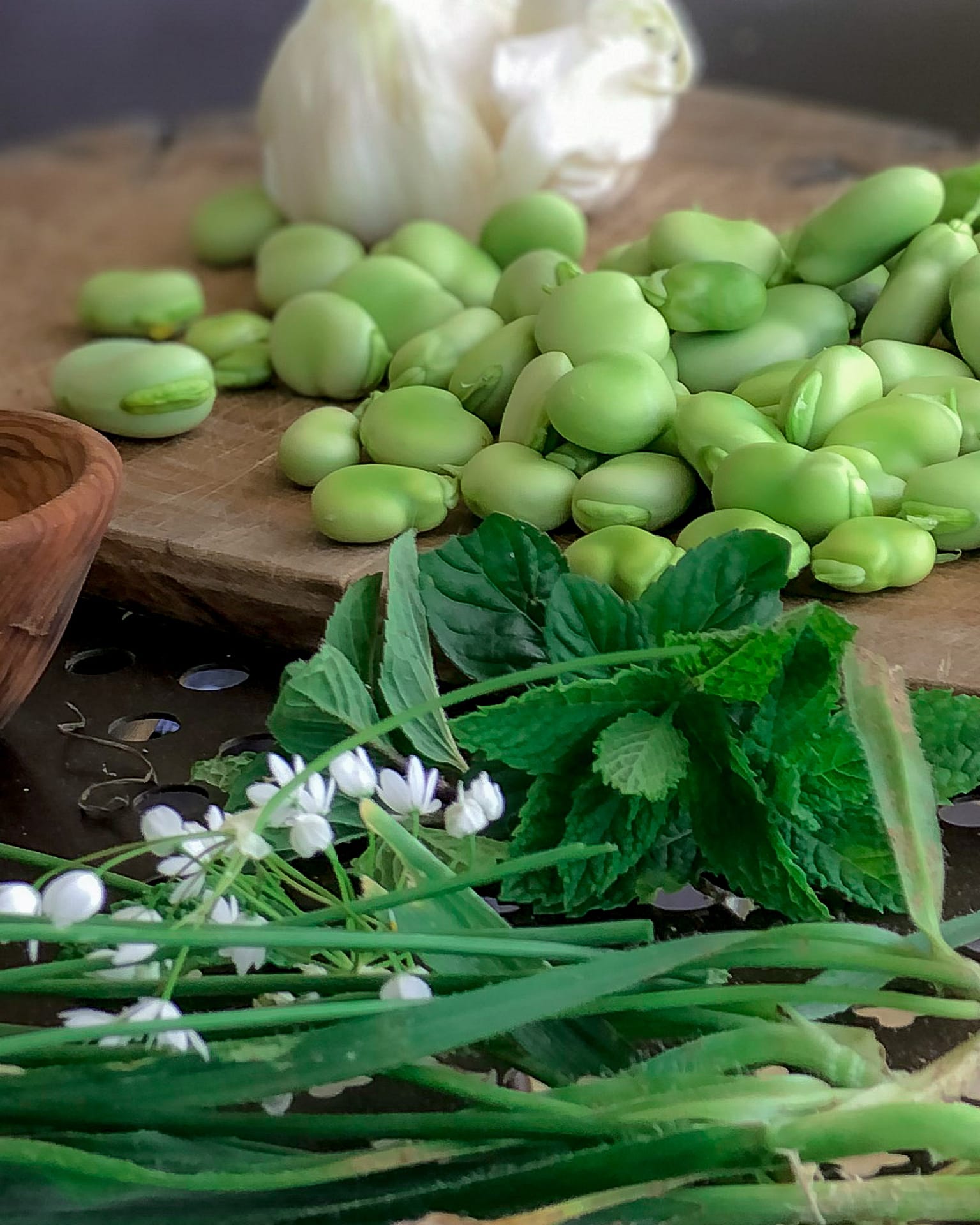 Fresh shelled broad beans on a chopping board