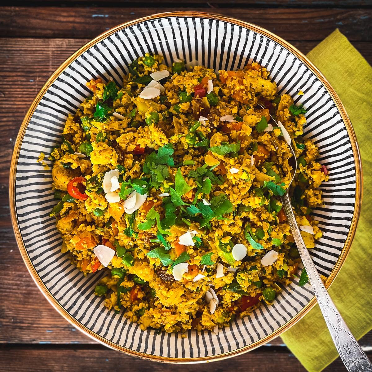 Cauliflower rice served in a decorative black and white bowl.