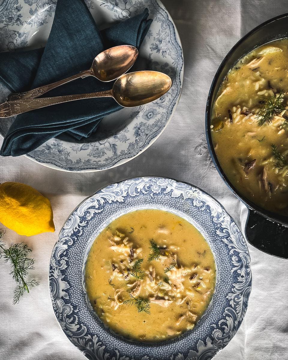 Antique blue and white plate with Greek Lemon Chick Soup decorated with dill.
