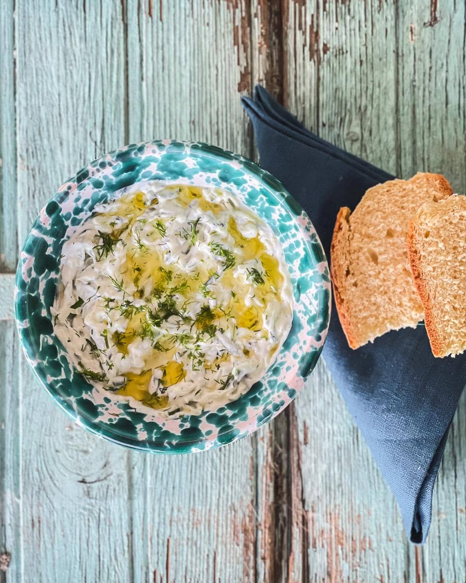 Tzatziki served in a decorative green speckled bowl