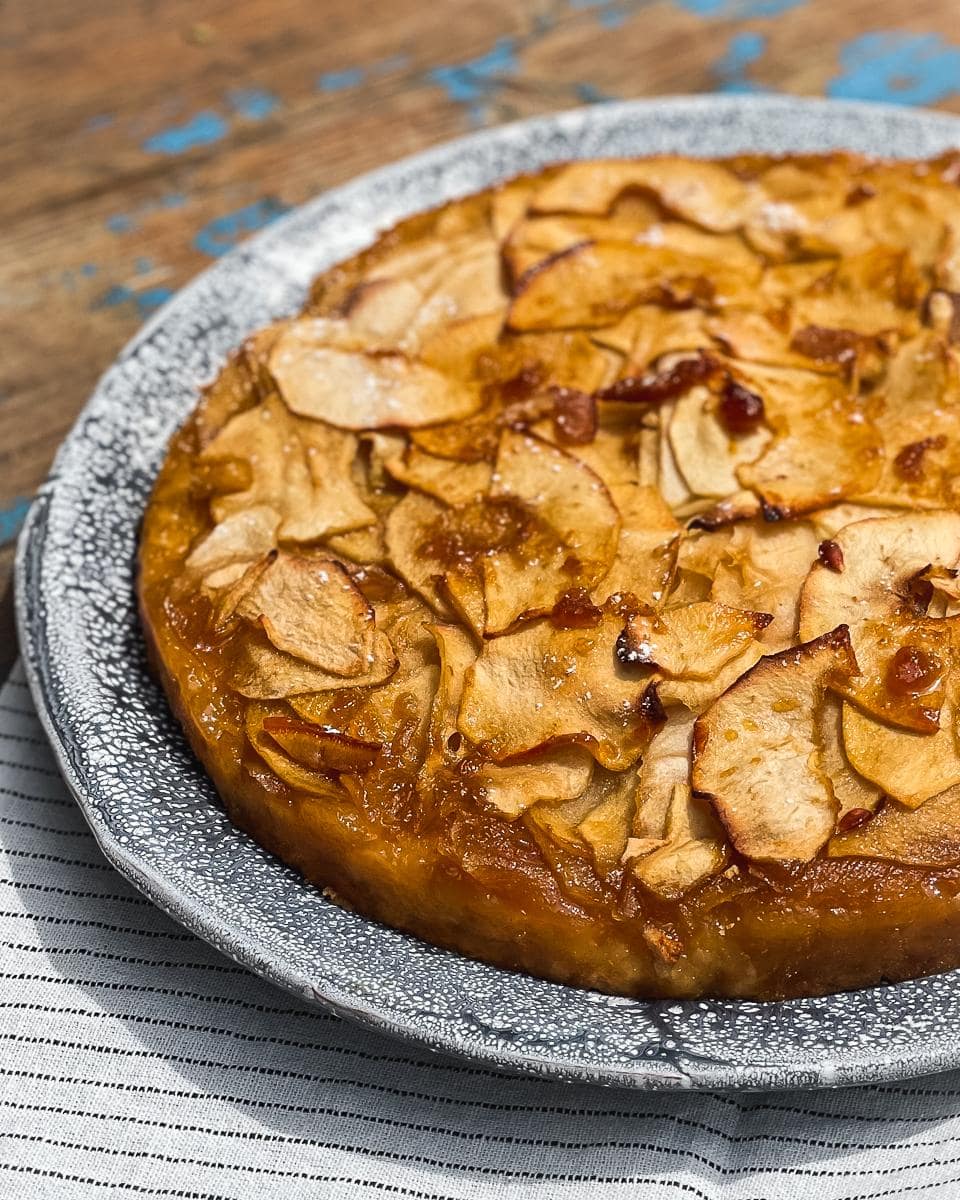 Italian style apple cake with wafer thin apples on top of a sponge cake