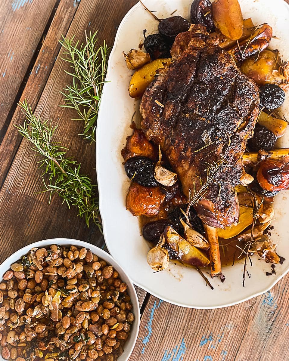 Lamb coated in a lemon and rosemary crust and baked in the oven with plums and garlic