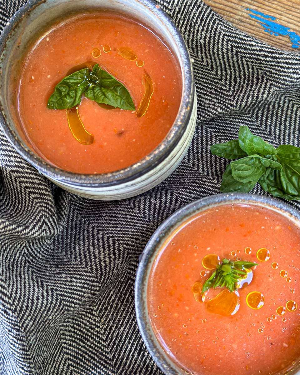 Gazpacho garnished with fresh basil and a drizzle of olive oil