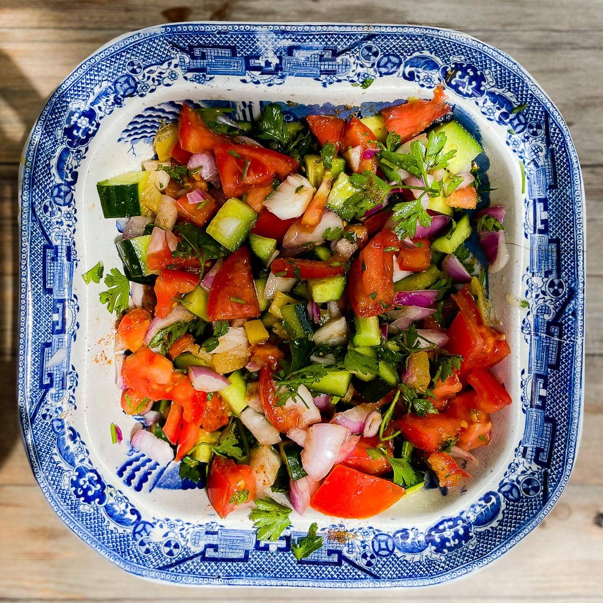 Indian salad served in an antique blue and white china bowl.