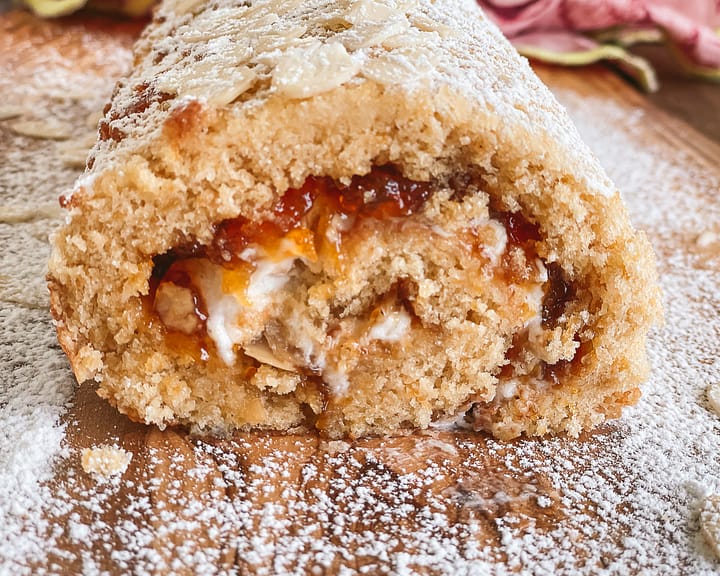 Apricot roulade filled with whipped cream and homemade apricot jam.