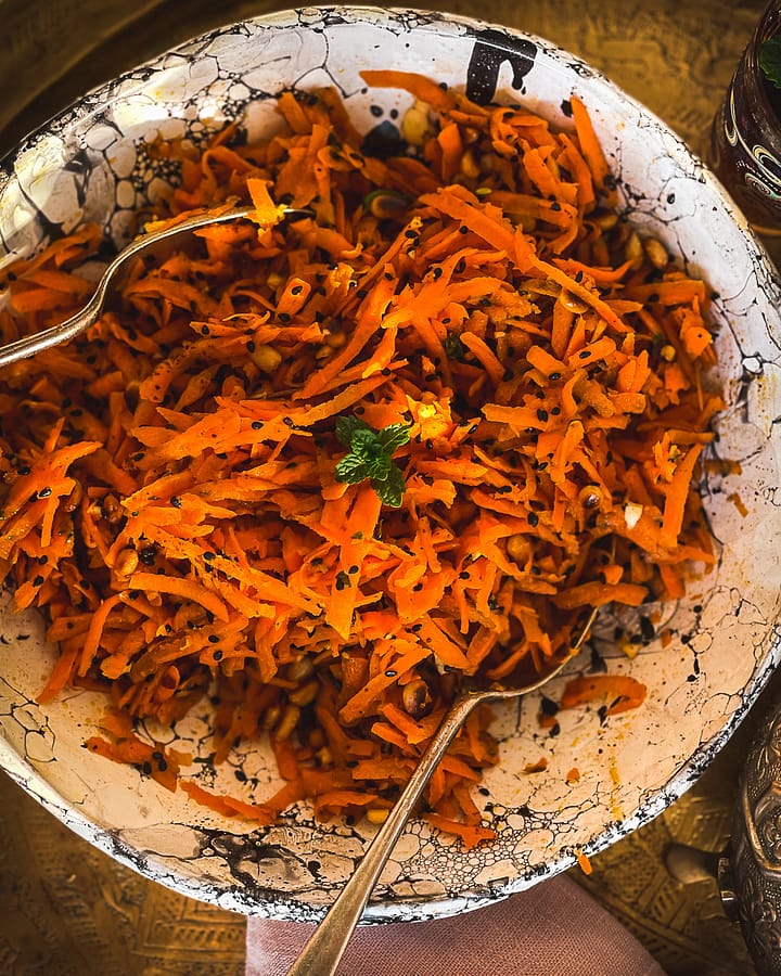 Moroccan inspired fresh raw carrot salad with baharat seasoning.