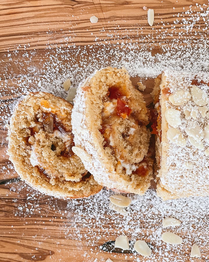 Slices of apricot roulade, dusted with powdered sugar. Ready for serving.