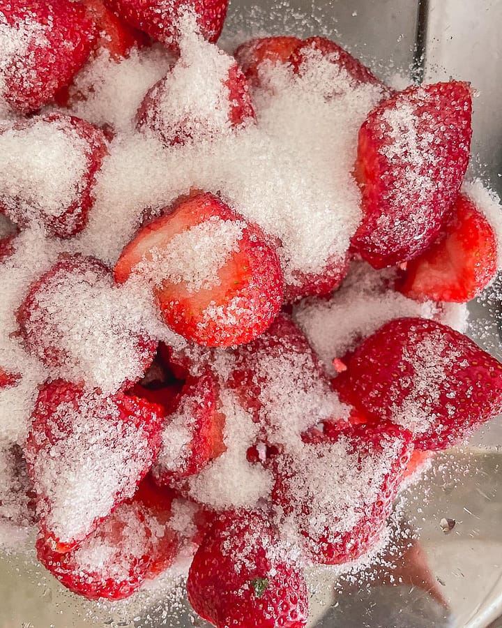 Preparing fresh strawberries for strawberry jam