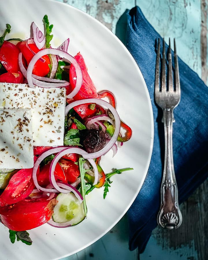 Authentic greek salad served in a large white bowl 