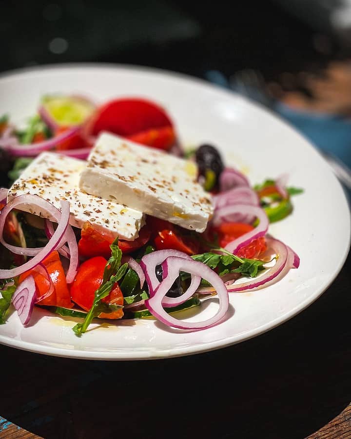 Traditional Horiatiki Greek salad with onions, feta, tomatoes and cucumbers