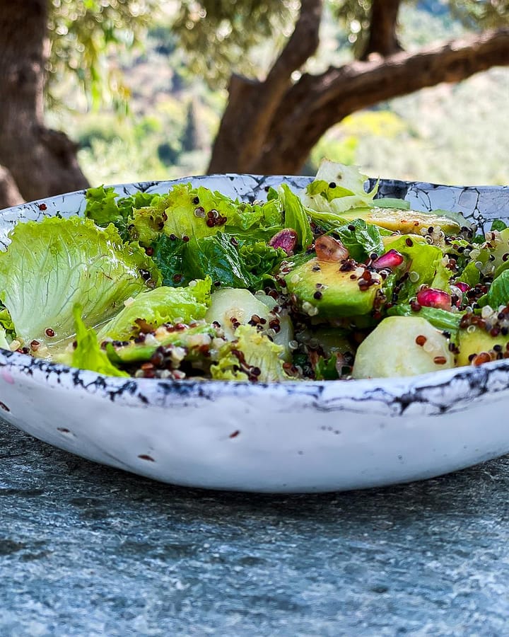 Quinoa salad with seasonal avocado and pomegranate seeds tossed in a za'atar dressing