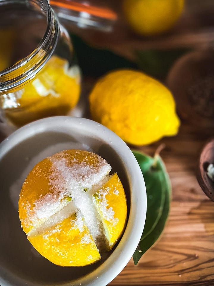 Lemon, cut and salted ready to preserve in a kilner jar.