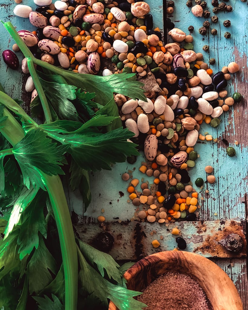 A wide mix of beans on a wooden table. Variety makes a great Bean Soup