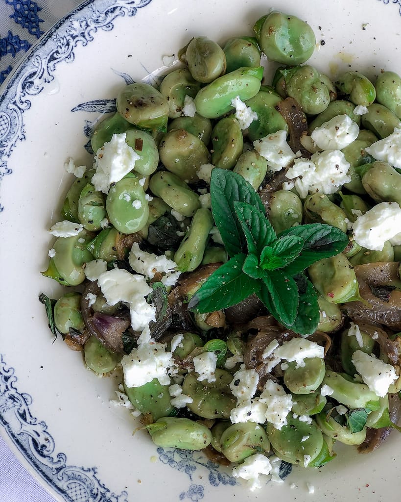 Blue and white bowl with broad beads, mint and feta.