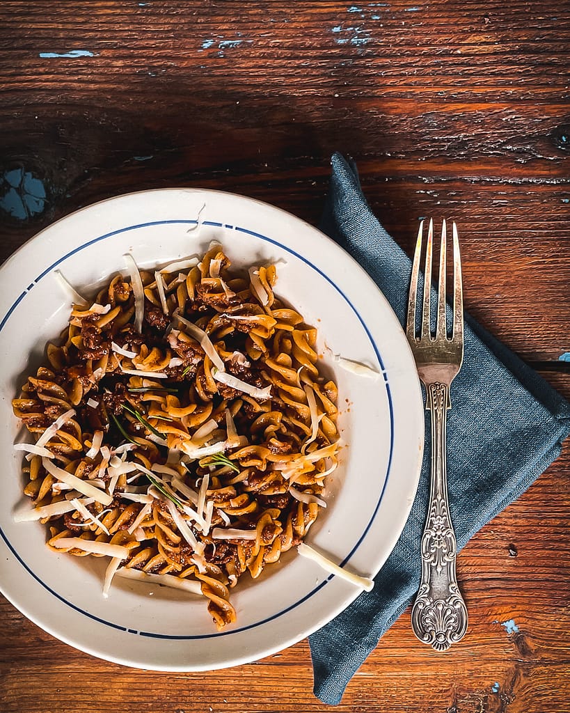 A bowl of fusilli pasta with a goose ragu sauce.