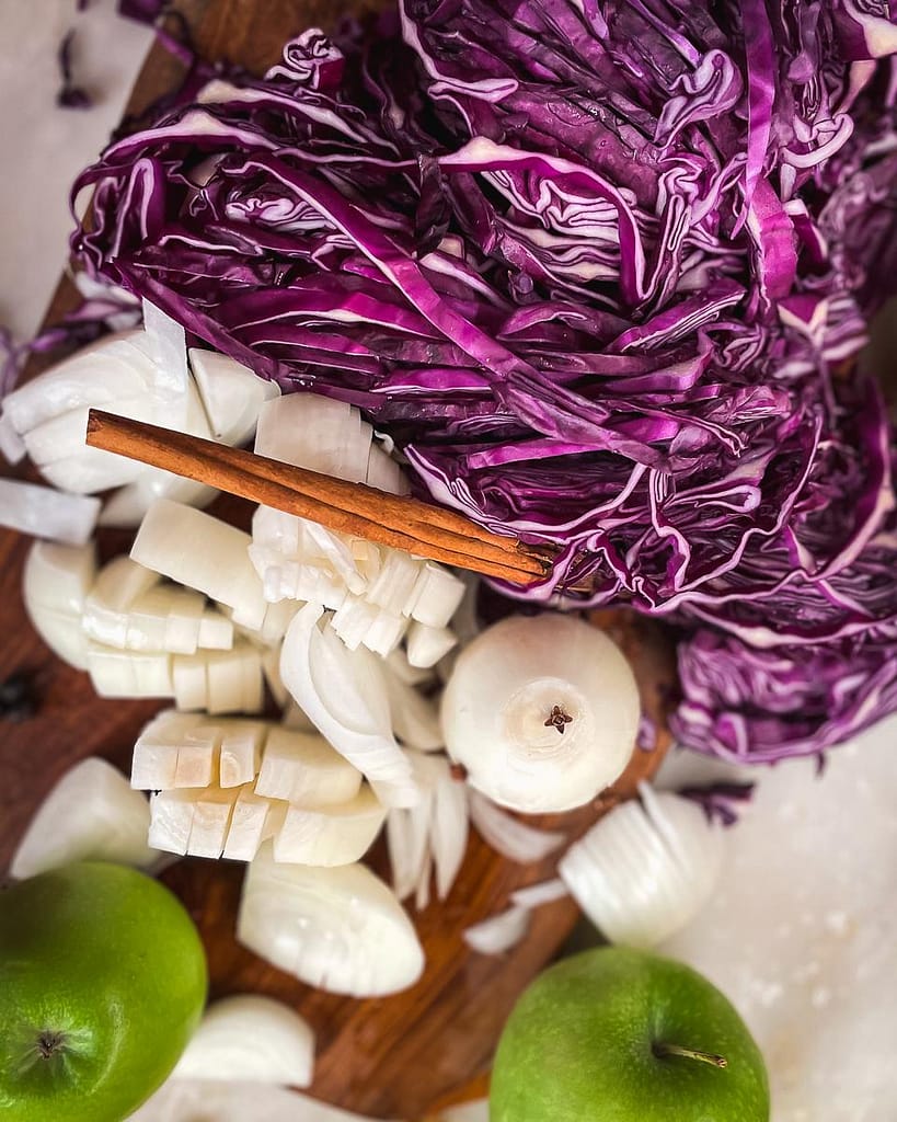 Ingredients prepared for braising red cabbage with apple.