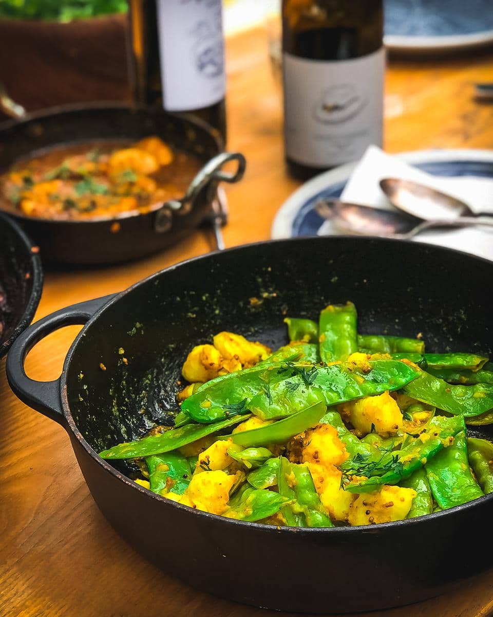 Lunch table with mangetout and potato stir fry and Kerala Coconut Prawns
